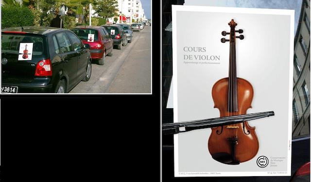 Violin flyer placed under windscreen wiper so that wiper looks like bow of violin.