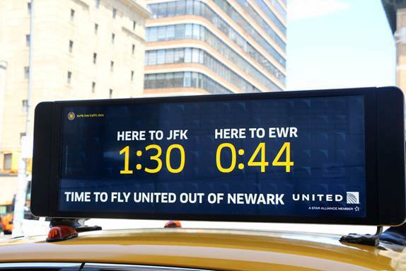 Taxi sign: Here to JFK 1:30 Here to EWR 0:44
