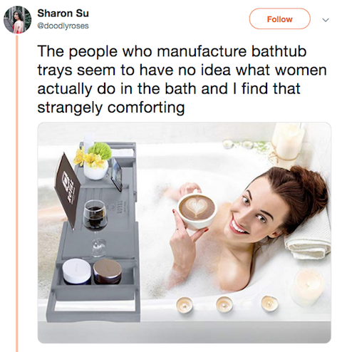 Pic lady in bath smiling with huge bathtub tray. "The people who manufacture bathtub trays seem to have no idea what women actually do in the bath and I find that strangely comforting"